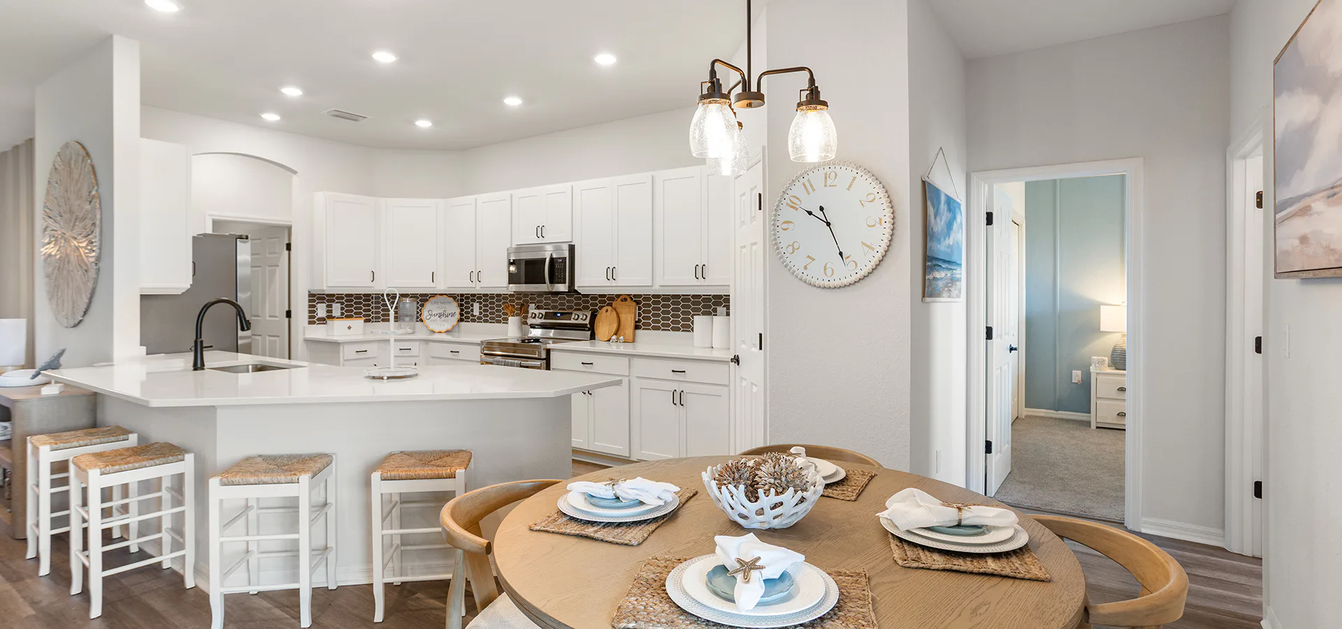 Kitchen with white cabinets and dark metal accents in the Westin II by Highland Homes in Ocala.