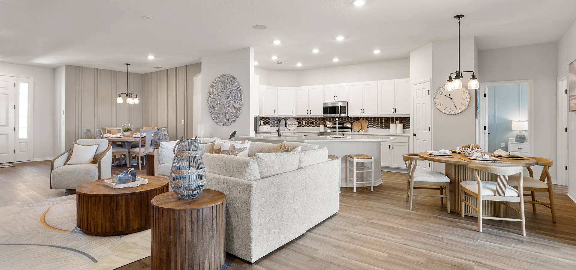 Living area and kitchen with mixed wood and white decor