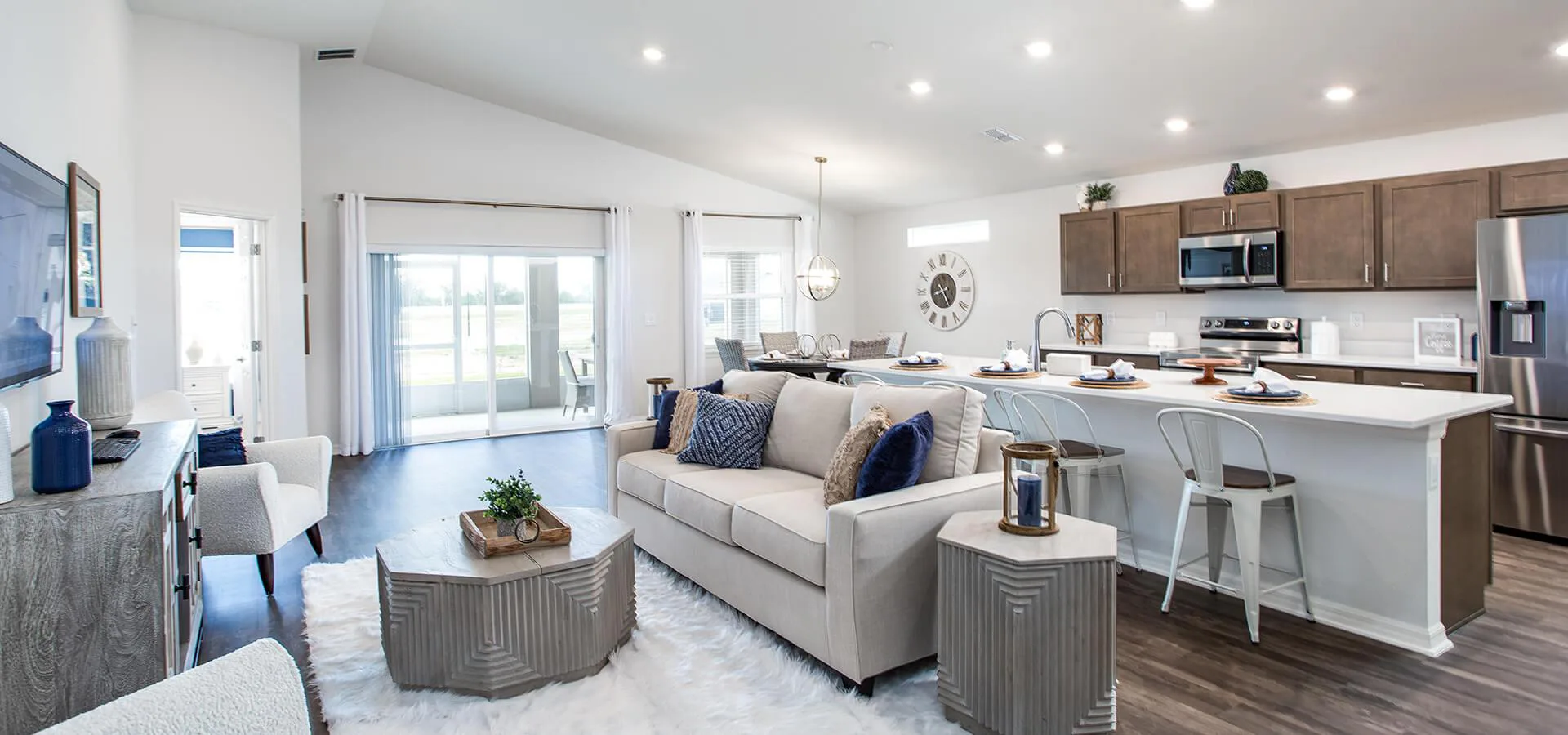 Open living area with light neutral colors and metallic accents
