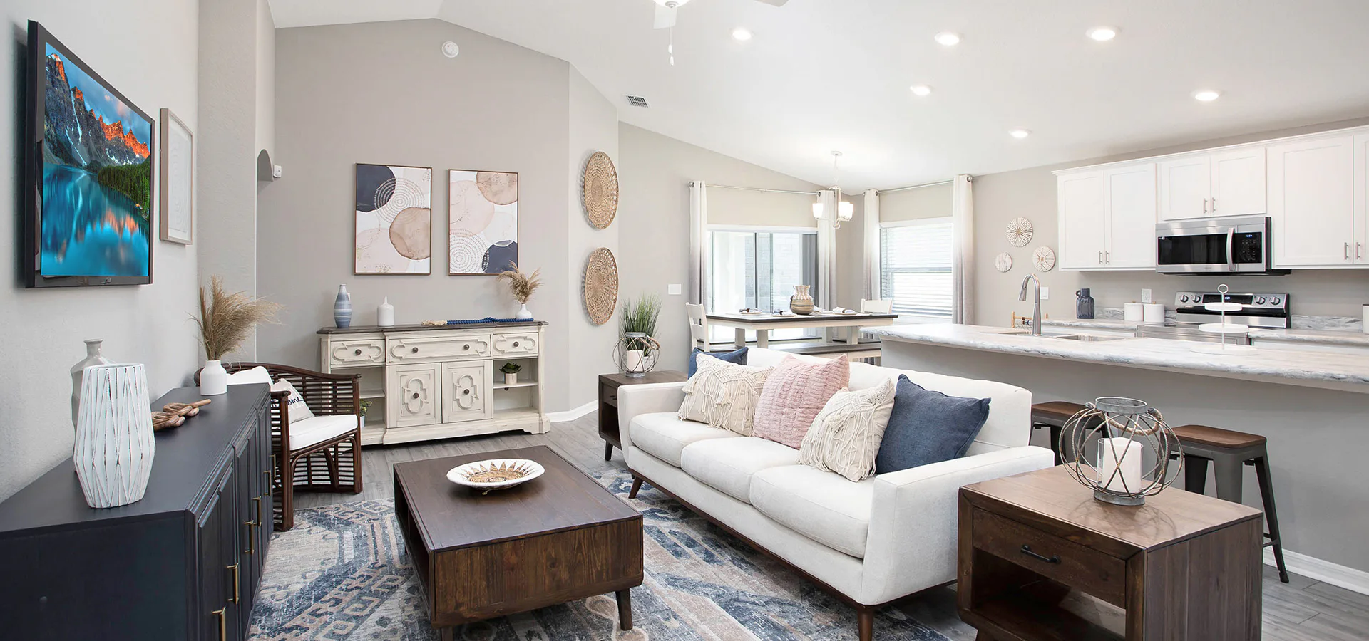 An open living area decorated with white, blue, and pink decor