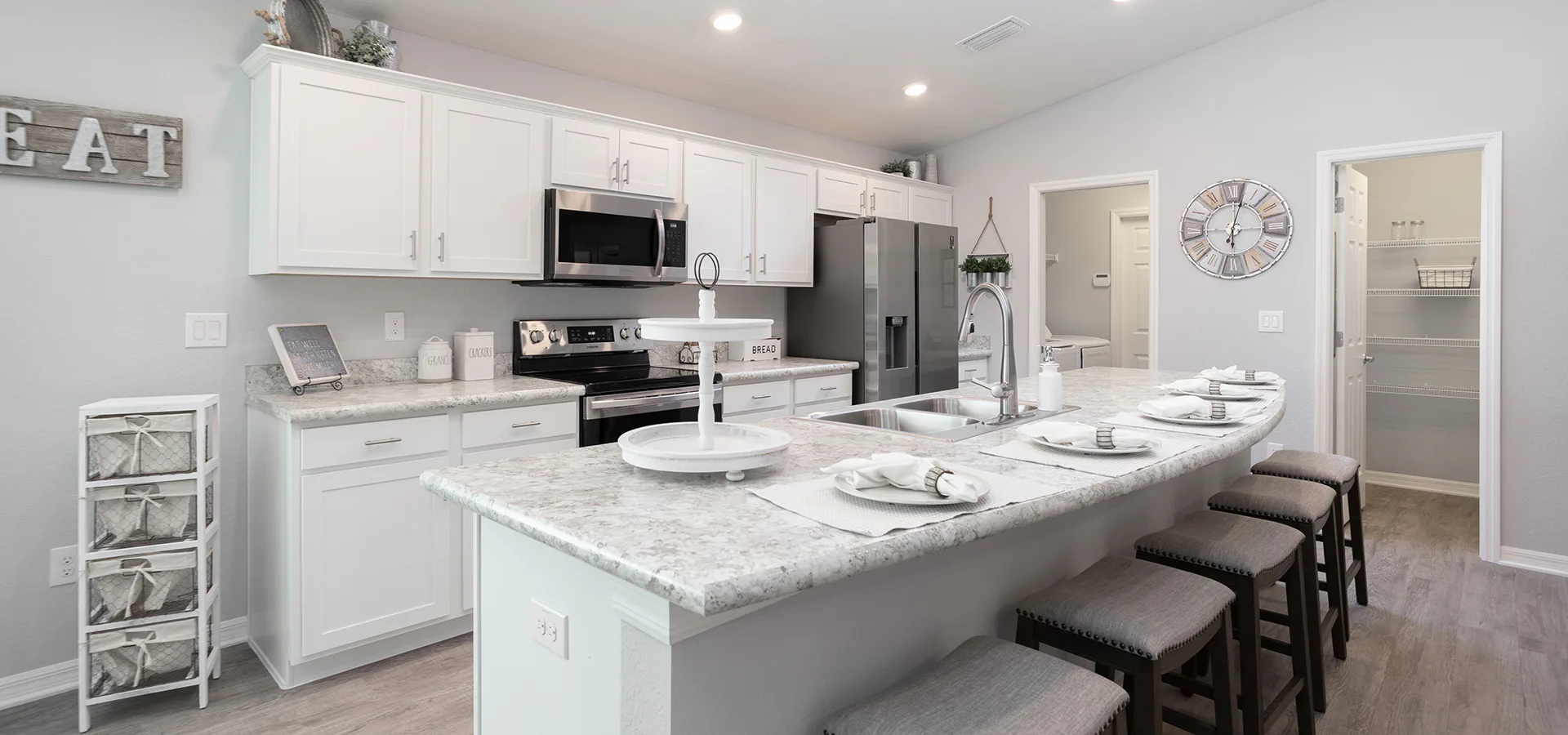 Island kitchen with neutral and white colors in Highland Homes' Raychel home plan