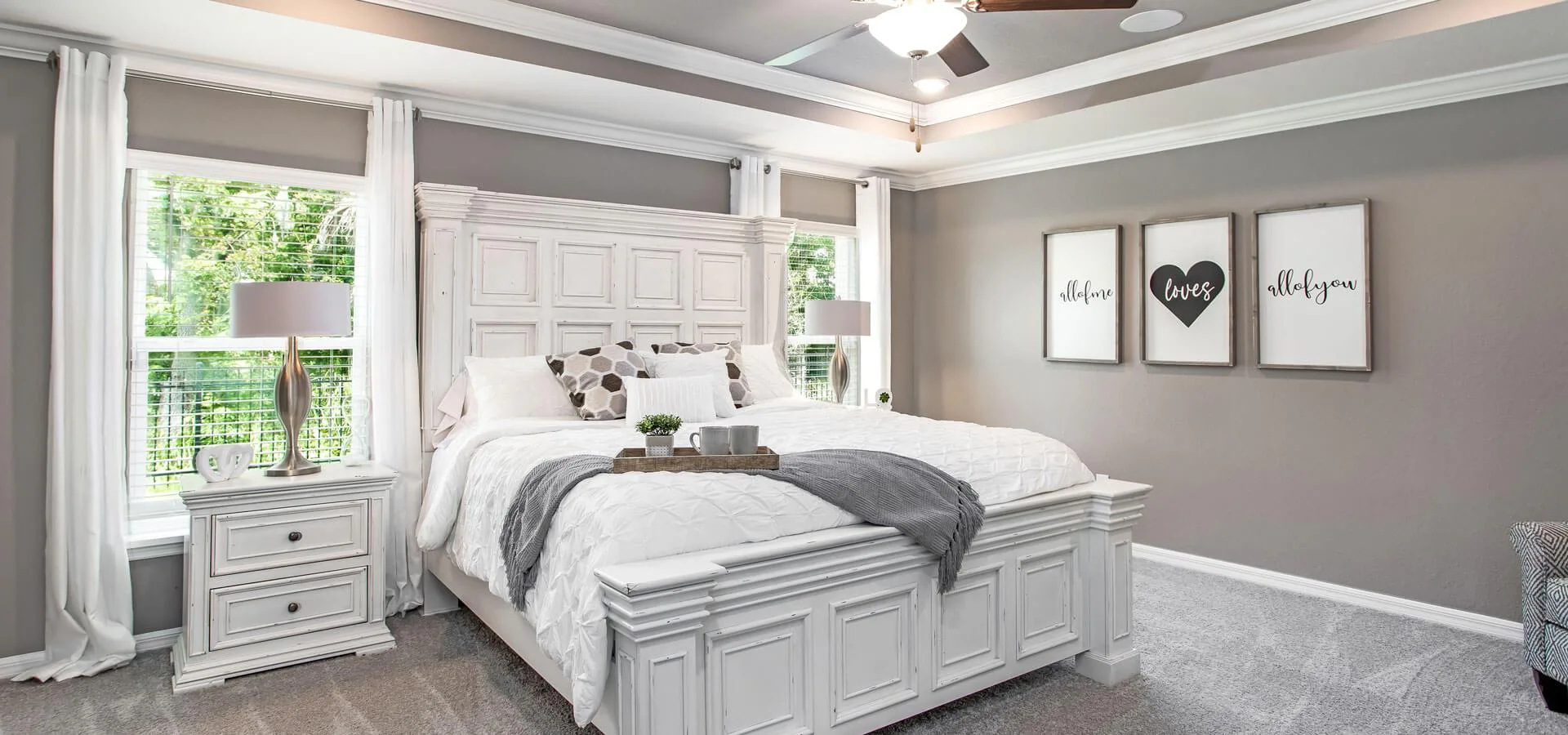 Large owner's suite with eloquent tray ceiling in the Raychel, a new home plan by Highland Homes