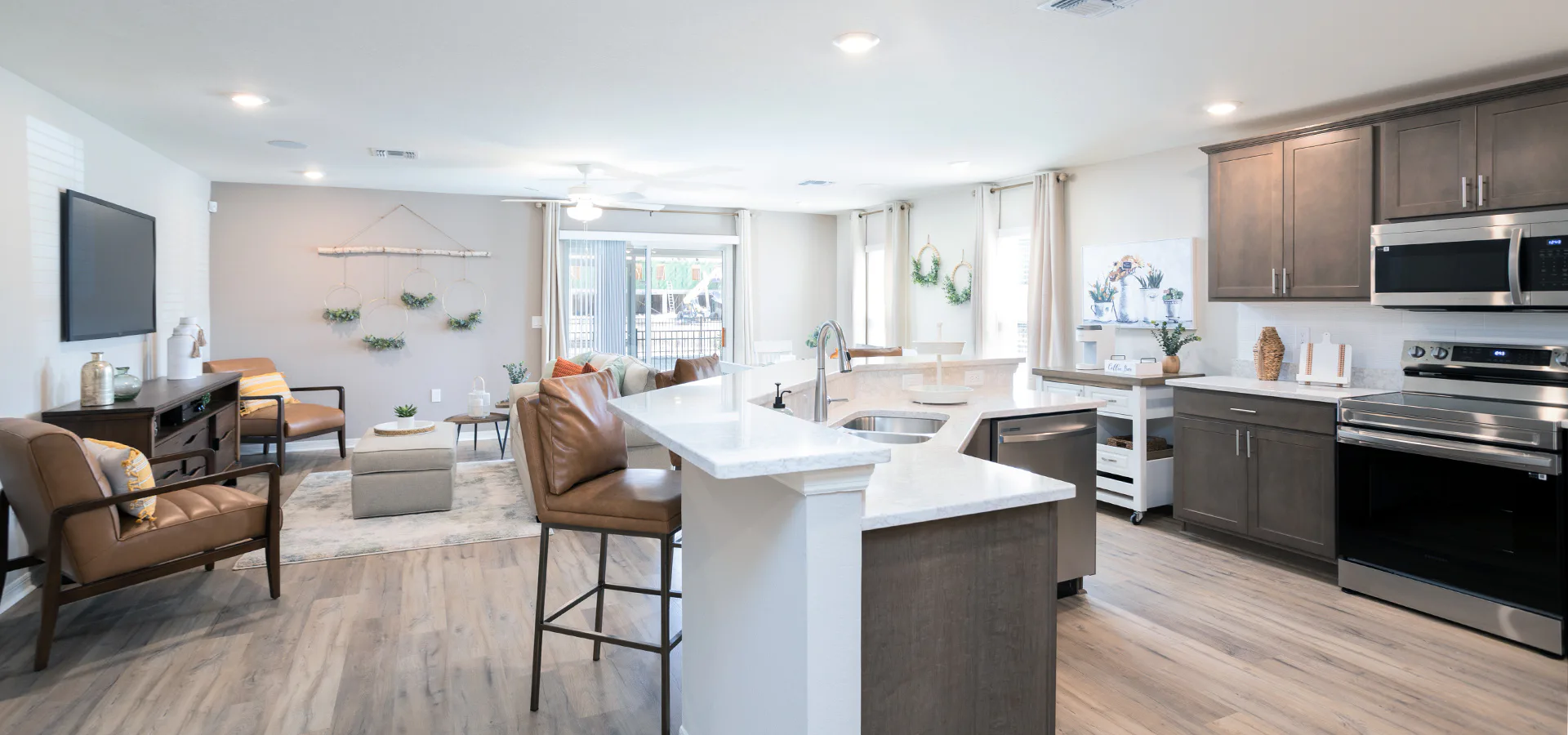 Open kitchen and living area with warm natural woods and leather furntiure