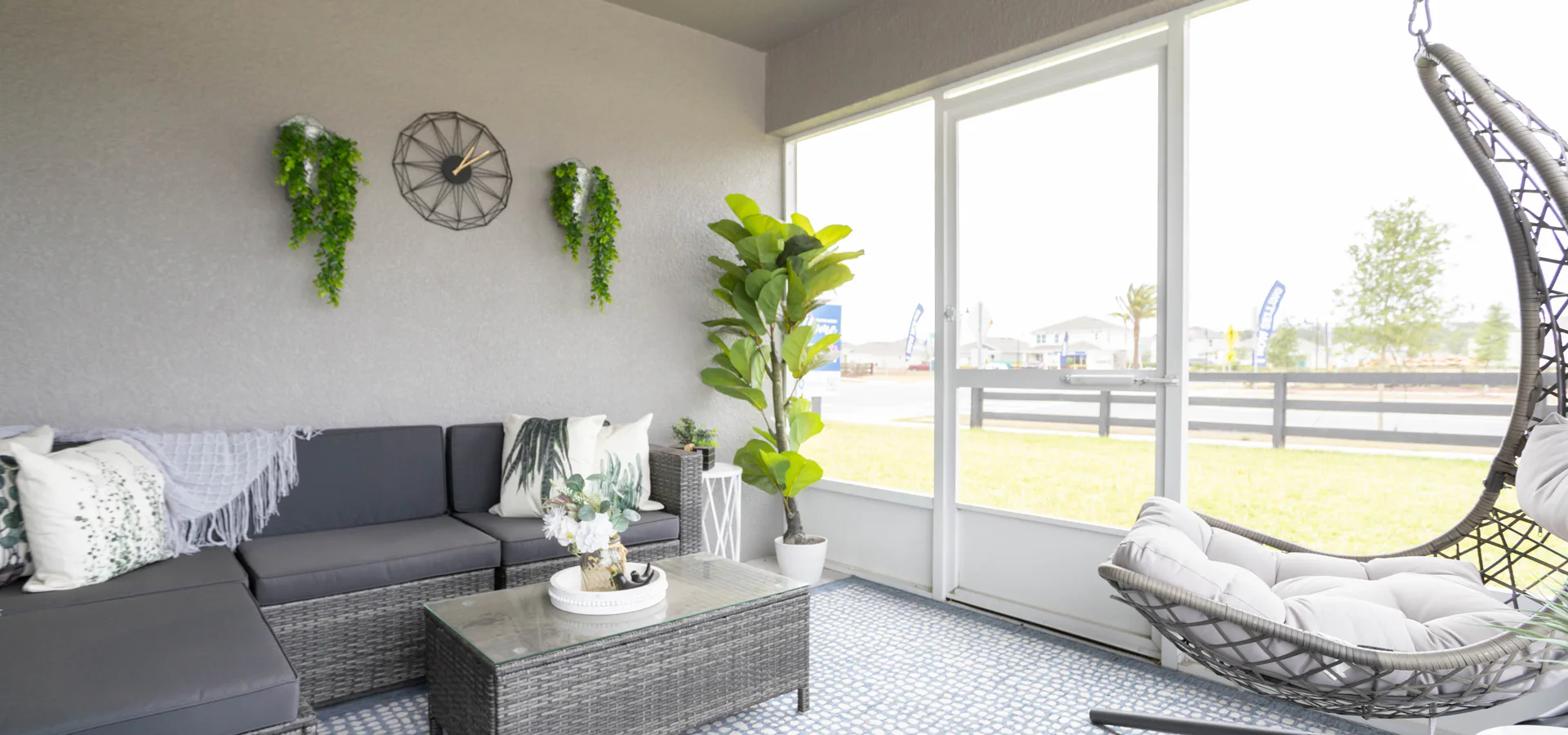 Covered lanai with sectional patio furniture and hanging chair with optional screening - Raychel home plan by Highland Homes