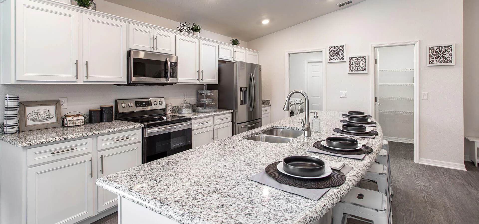Modern kitchen with white cabinetry and stainless steel appliances