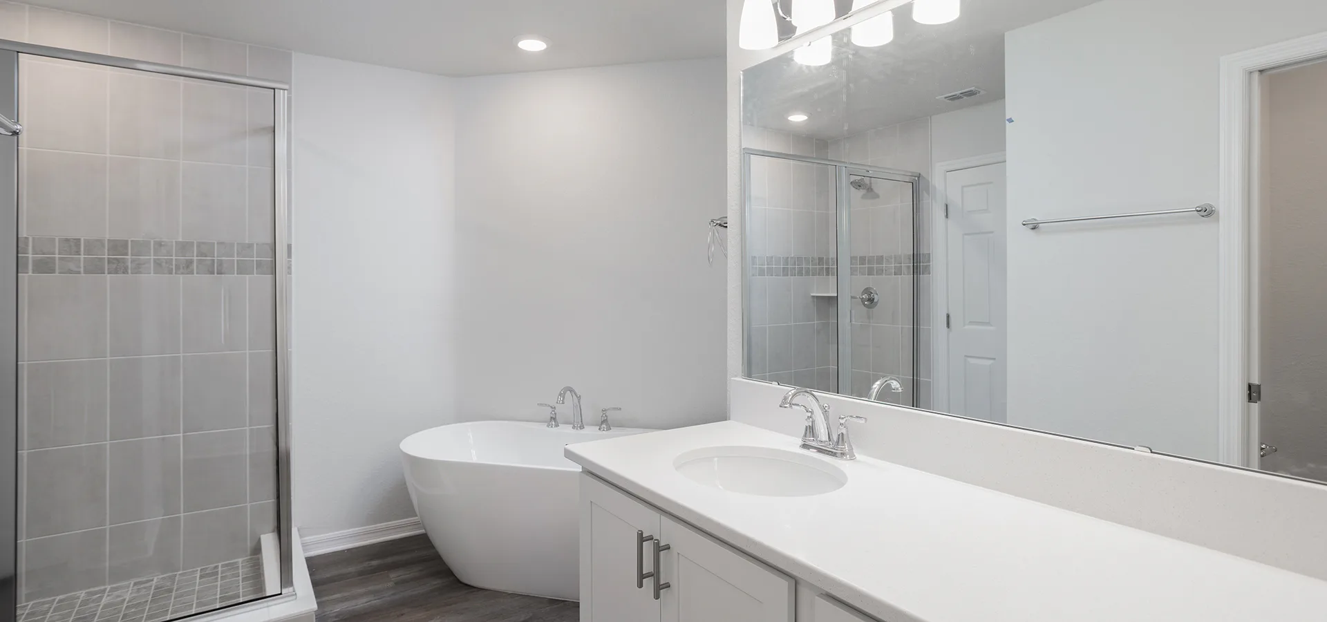Spacious en-suite bathroom with a freestanding tub and tiles shower, in a Saint Cloud, Florida new home